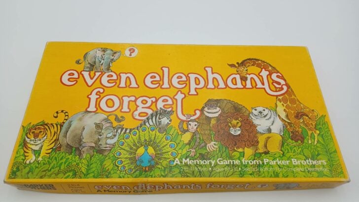 A picture of Even Elephants Forget's box featuring an elephant with a ? dialog box, the game's title in white and red, and pictures of most of the animals in the game (a tiger, rhino, zebra, peacock, monkey, gorilla, lion, polar bear, and giraffe).