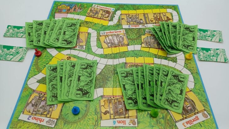 This picture shows the end of the game with all animal cards returned to their cages and each player's reward money counted up. The yellow player has the most money ($9) and wins the game.