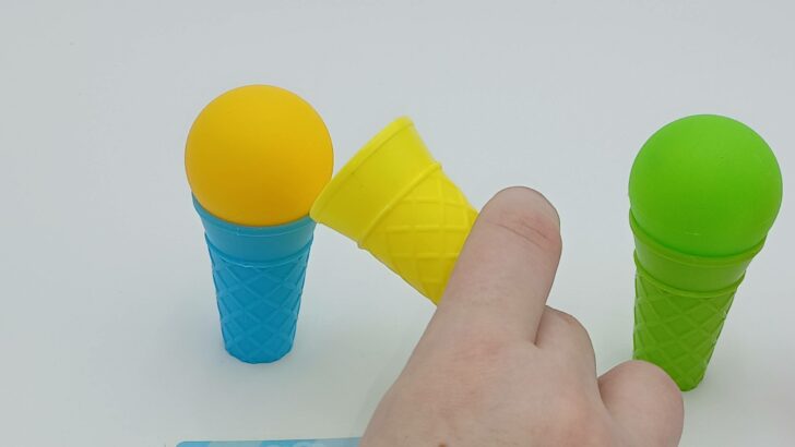This player is moving a yellow scoop of ice cream to a blue cone to try to match the challenge card.