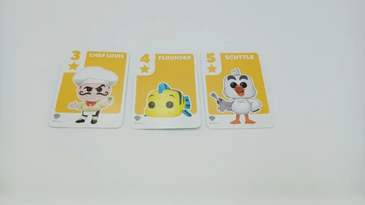 This picture shows a player completing a run in Something Wild!: The Little Mermaid. They have a yellow three card (Chef Louis), a yellow four (Flounder), and a yellow five (Scuttle) card in front of them.