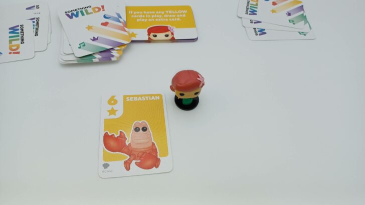This picture shows the player taking the Ariel figure as their Sebastian card is yellow, matching the color of the Power card in the middle of play.