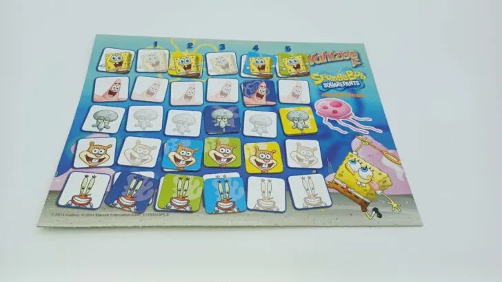 This picture shows the scoreboard at the end of the game. The yellow player scored five from Squidward, four from Sandy, and two from SpongeBob. The green player scored five from SpongeBob, three from Sandy, and two from Mr. Krabs. The blue player got four from SpongeBob, three from Mr. Krabs, and two from Sandy. Finally, the purple player scored four from Patrick, three from Squidward, and one from Mr. Krabs. Those totals add up to 11 for yellow, 10 for green, 9 for blue, and 8 for purple. The yellow player has the most points and wins the game.