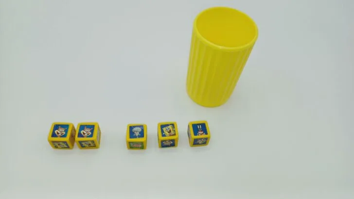 This picture shows a player's first roll in Yahtzee Jr.: SpongeBob SquarePants. They rolled two Sandy's, one Squidward, one SpongeBob, and a Mr. Krabs so they elect to keep the two Sandy dice and re-roll the rest.
