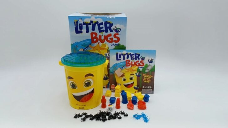 A picture of all of the components included in Litter Bugs: An electronic trash can and lid, 12 pieces of trash, blue and black flies, 1 die, and instructions.
