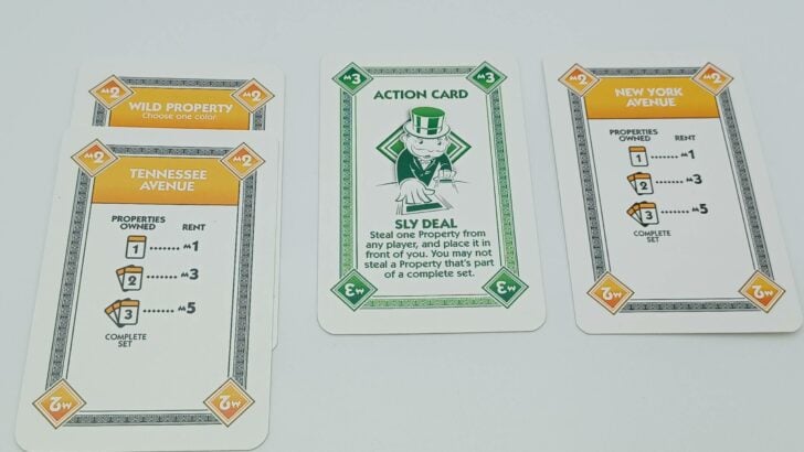 A player using a Sly Deal card to steal a card from another player.